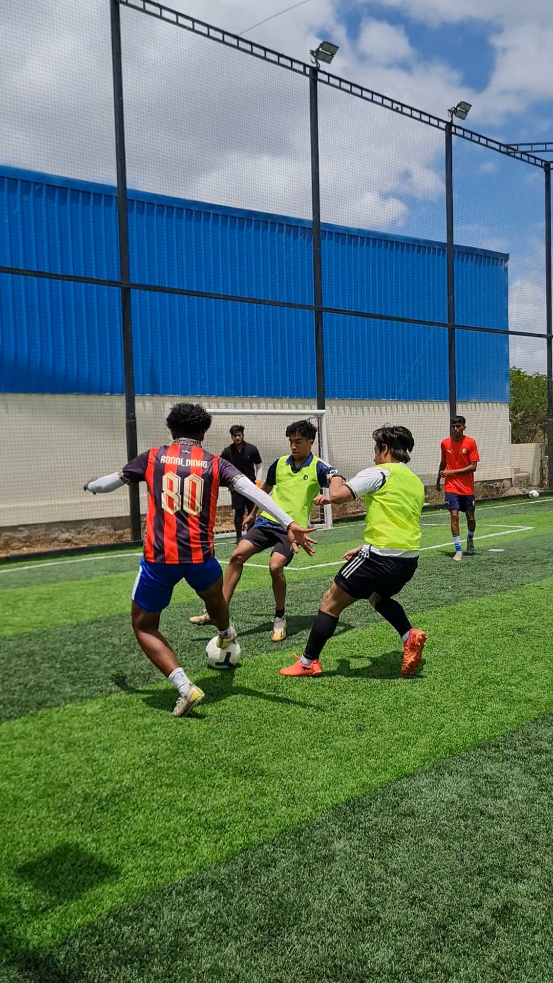 Midfield duel during a group-stage match at Hey Turf, Sarjapur